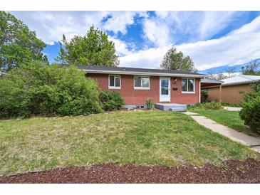 Charming red brick ranch-style home with a well-manicured lawn and mature landscaping at 1646 S Stuart St, Denver, CO 80219