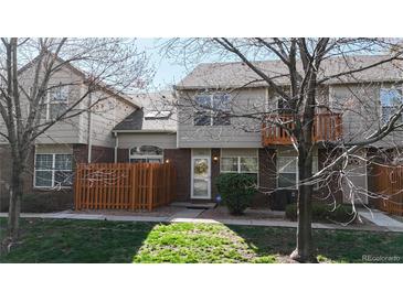 Charming townhome featuring well-maintained front yard, brick accents, and a cozy fenced-in patio area at 1381 W 112Th Ave # B, Westminster, CO 80234