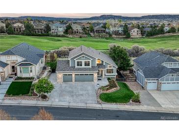 Charming two-story home with a well-manicured lawn and a three-car garage in a quiet neighborhood at 1497 Bent Grass Cir, Castle Rock, CO 80109