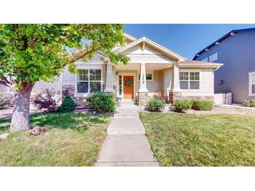 Charming single-story home featuring a welcoming front porch, manicured lawn, and lovely landscaping at 14230 Lakeview Ln, Broomfield, CO 80023