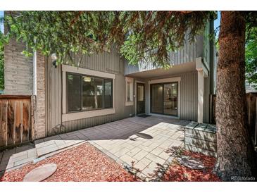 Charming patio area with new stone pavers and wood accents perfect for entertaining or relaxing outdoors at 1219 S Yosemite Way # 63, Denver, CO 80247