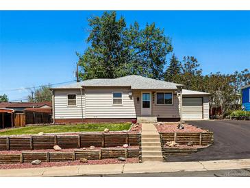 Charming single-story home with a well-maintained lawn and decorative wood retaining wall at 8881 Lilly Dr, Thornton, CO 80229