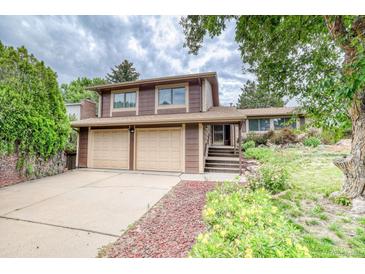 Charming two-story home featuring an attached two car garage and well-maintained landscaping at 2621 S Kingston Ct, Aurora, CO 80014