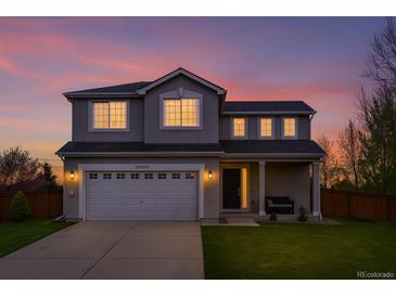 Charming two-story home featuring a well-manicured lawn and an attached two-car garage at 21005 Glacier Park Cv, Parker, CO 80138