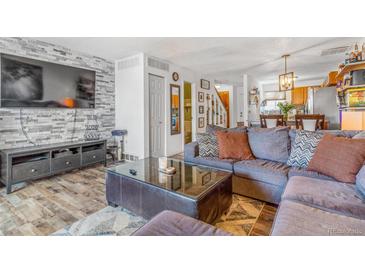 Inviting living room featuring a stone accent wall and comfortable seating area at 2279 Coronado Pkwy # B, Denver, CO 80229