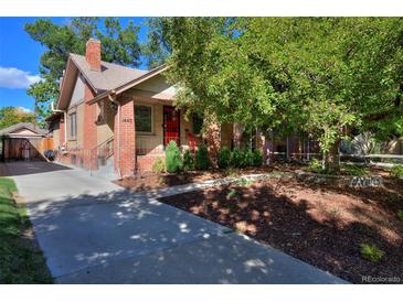 Brick home with landscaped yard and a driveway at 1445 Elm St, Denver, CO 80220