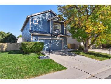 Two-story blue home with a two-car garage and basketball hoop at 11220 Keota St, Parker, CO 80134