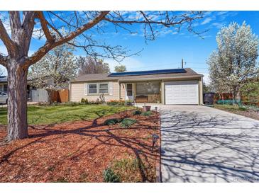Charming single-story home with well-manicured lawn and solar panels on the roof at 5085 E Missouri Ave, Denver, CO 80246