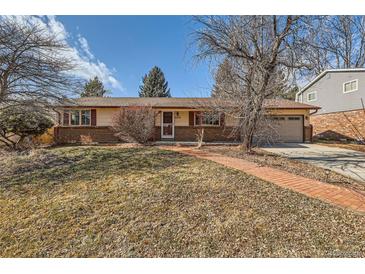 Charming single-story home featuring a brick walkway and manicured front yard at 6259 S Fenton Ct, Littleton, CO 80123