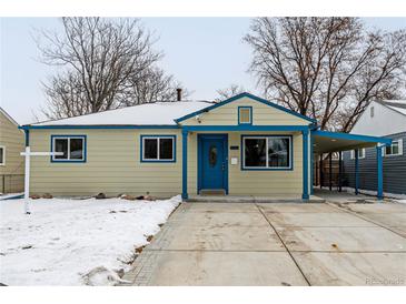 Tan house with blue accents, covered porch, and snow-covered yard at 1770 Akron St, Aurora, CO 80010