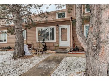 Charming home featuring a cozy front entrance with mature trees and walkway at 841 Crisman Dr # 9, Longmont, CO 80501