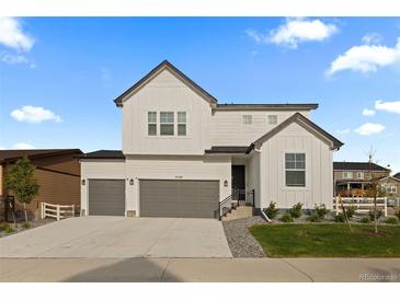 Beautiful modern farmhouse with a three-car garage and eye-catching curb appeal at 4739 Gray Wolf Ln, Castle Rock, CO 80104