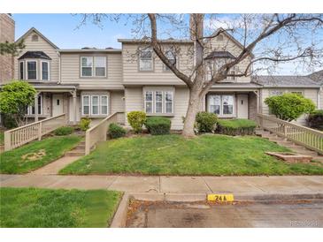 Charming townhome featuring a landscaped front yard and inviting entrance stairs at 9624 W Chatfield Ave # D, Littleton, CO 80128