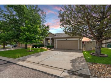 Charming single-Gathering home with a well-manicured front yard, mature trees and a two-car garage at 8240 Clayton Ct, Denver, CO 80229