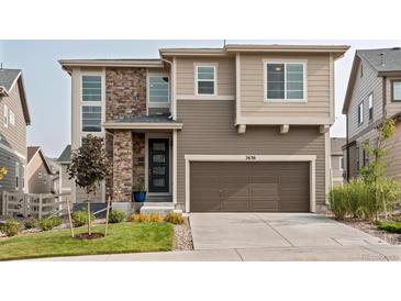 Charming two-story home featuring stone accents, a well-maintained lawn, and an attached two-car garage at 2636 Scoter Ln, Castle Rock, CO 80104