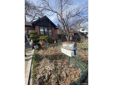 Modest home with a yard needing love and mailboxes, in need of tender care at 2293 S Galapago St, Denver, CO 80223