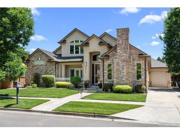 Beautiful two-story home featuring a well-maintained lawn and brick accents at 222 S Olive St, Denver, CO 80230