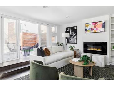 Bright living room with sliding doors to patio, modern fireplace, and stylish decor at 3635 Osage St, Denver, CO 80211