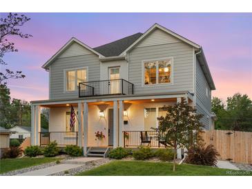 Charming two-story home with a welcoming front porch and beautiful landscaping at 3256 S Corona, Englewood, CO 80113