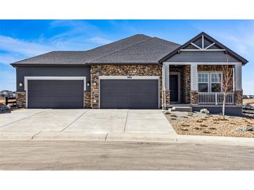 Beautiful two-story home with stone accents, a three car garage, and manicured landscaping at 3884 Freestone Pt, Castle Rock, CO 80108
