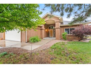 Charming home featuring a covered entrance and well-maintained front yard landscaping at 20401 High Pines Dr, Monument, CO 80132