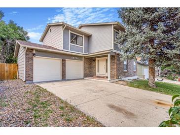 Inviting two-story home featuring a brick facade and a spacious two-car garage for modern living at 18751 E Mexico Ave, Aurora, CO 80017