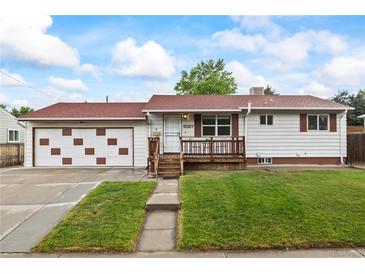 Charming single-story home with a cozy front porch and well-maintained lawn at 6327 Fenton St, Arvada, CO 80003