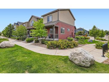 Charming two-story home with a welcoming front porch and beautiful landscaping at 1199 Hummingbird Cir, Longmont, CO 80501