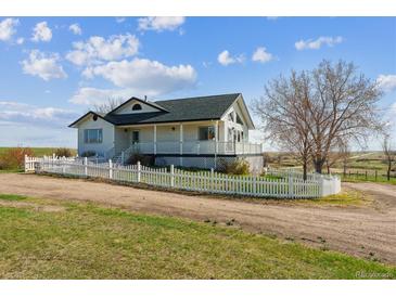 Charming two-story home with a white picket fence and inviting front porch at 371 Buckskin Ct, Parker, CO 80138
