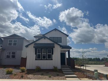 Charming two-story home boasts a modern design with black trim and a well-maintained landscaped yard at 2070 Wagon Wheel Aly, Brighton, CO 80601