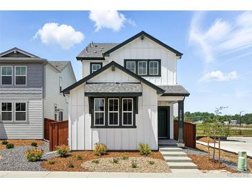 Charming two-story home features a modern white exterior with a landscaped front yard and welcoming entrance at 2070 Wagon Wheel Aly, Brighton, CO 80601