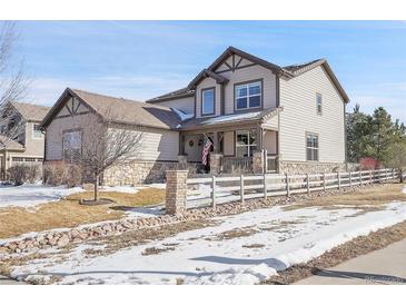 Two-story house with stone accents and a landscaped yard at 16686 Rinker Way, Broomfield, CO 80023