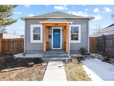 Charming home featuring a bright blue front door and natural wood accents at 104 Stuart St, Denver, CO 80219
