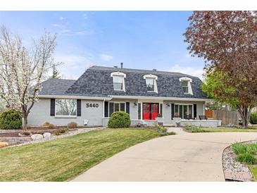 Charming single Gathering home with landscaped front yard and eye-catching red front door at 5440 W Hinsdale Ave, Littleton, CO 80128