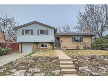 Charming two-story home with a brick and siding facade, featuring an attached garage and a well-maintained front yard at 4257 Graham Ct, Boulder, CO 80305