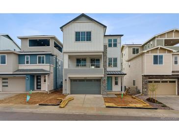 New construction home showing a modern elevation, blue door and landscaping at 8229 Butte Creek St, Littleton, CO 80125