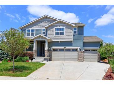 Charming two-story home featuring a three-car garage, landscaped yard, and a welcoming entrance at 2474 Ravenswood Ct, Longmont, CO 80504