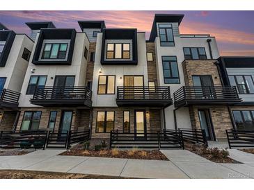 Stunning modern townhome exterior featuring private balconies and a stone and stucco facade at 2323 Lakeshore Ln # 11, Superior, CO 80027