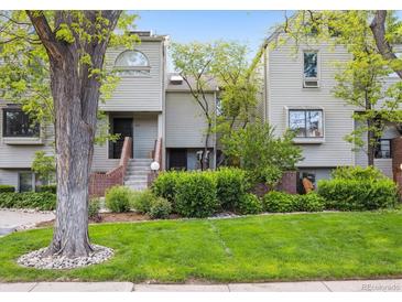 Charming townhomes with a well-manicured lawn and mature landscaping, creating an inviting curb appeal at 345 Harrison St, Denver, CO 80206
