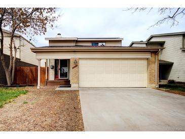 Charming home featuring a spacious two-car garage and a welcoming front porch at 11771 Pennsylvania St, Northglenn, CO 80233