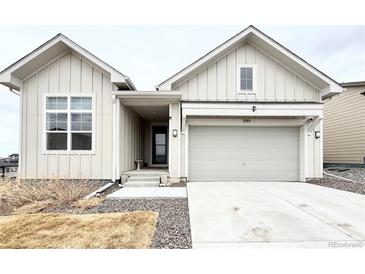 Inviting home featuring light siding, a two-car garage, and a well-maintained front yard at 295 Kitselman Dr, Castle Rock, CO 80104