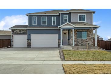 Two-story home with stone accents and a three-car garage at 4410 Cattle Cross Rd, Castle Rock, CO 80104