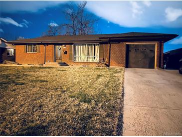 Well-kept single-story brick home with attached garage and manicured front lawn at 413 Jamaica St, Aurora, CO 80010