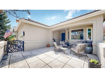 Outdoor patio features tiled flooring and seating with comfortable chairs and lovely landscaping at 9559 Brook Hill Ln, Lone Tree, CO 80124