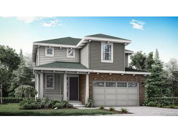 Charming two-story home with a brick accent and an attached two-car garage, surrounded by lush landscaping at 7387 S Yank Ct, Littleton, CO 80127