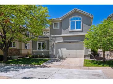 Two-story home with a well-manicured lawn and a two-car garage at 11969 E Lake Cir, Greenwood Village, CO 80111