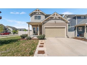 Charming two-story home featuring a two-car garage and a well-maintained lawn with manicured landscaping at 4405 Walden Ct, Denver, CO 80249