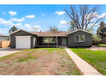Charming single story home with a freshly painted gray exterior and a well-manicured lawn at 4320 Lamar St, Wheat Ridge, CO 80033