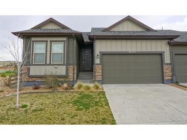 Charming single Gathering home featuring a two-car garage and neutral colored exterior at 11860 Sandcastle Ct, Parker, CO 80138
