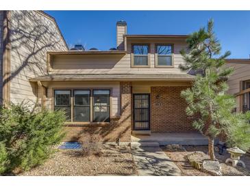 Charming two-story townhome featuring a brick facade, well-maintained landscaping, and a cozy front entrance at 1013 Homestake Dr # 17C, Golden, CO 80401
